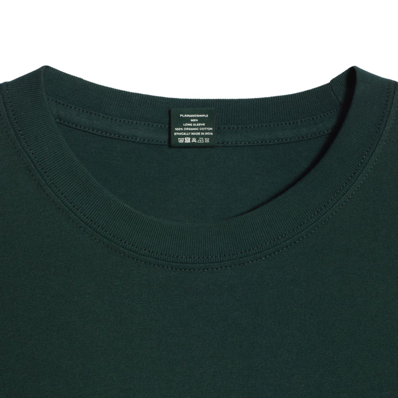 A close up of a neck label in a men's green long sleeve crew neck organic cotton t shirt.