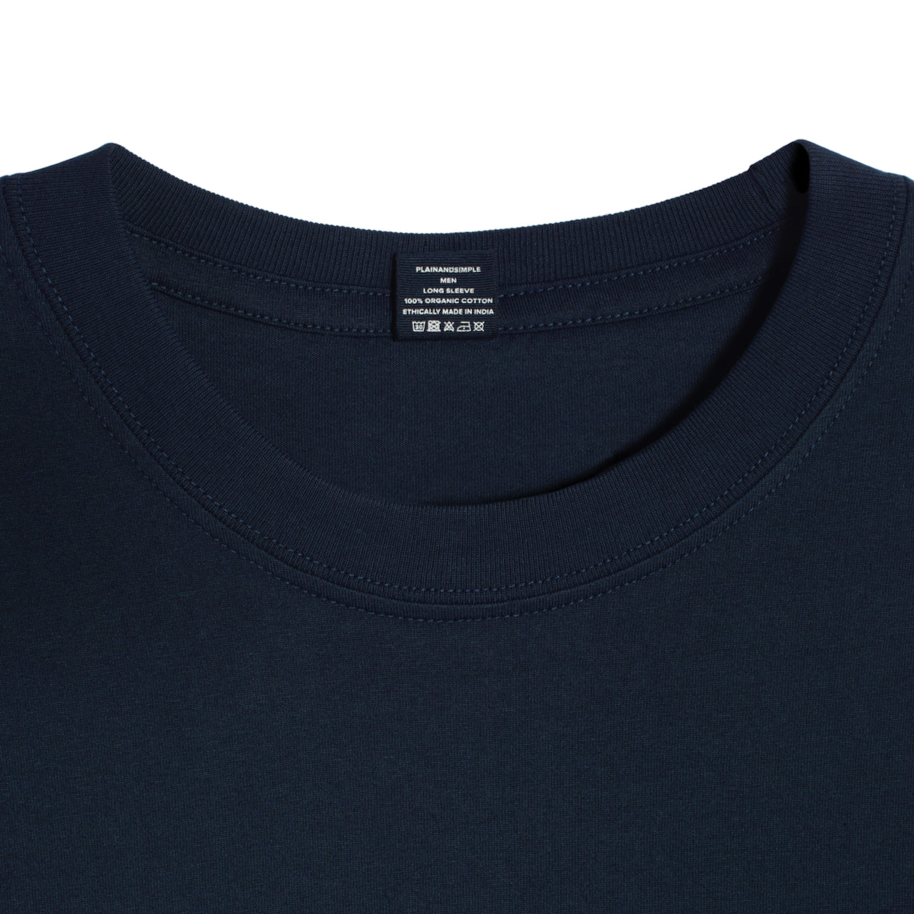 A close up of a neck label in a men's dark navy sleeve crew neck organic cotton t shirt.