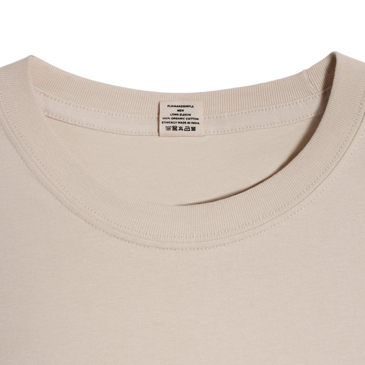 A close up of a neck label in a men's stone long sleeve crew neck organic cotton t shirt.