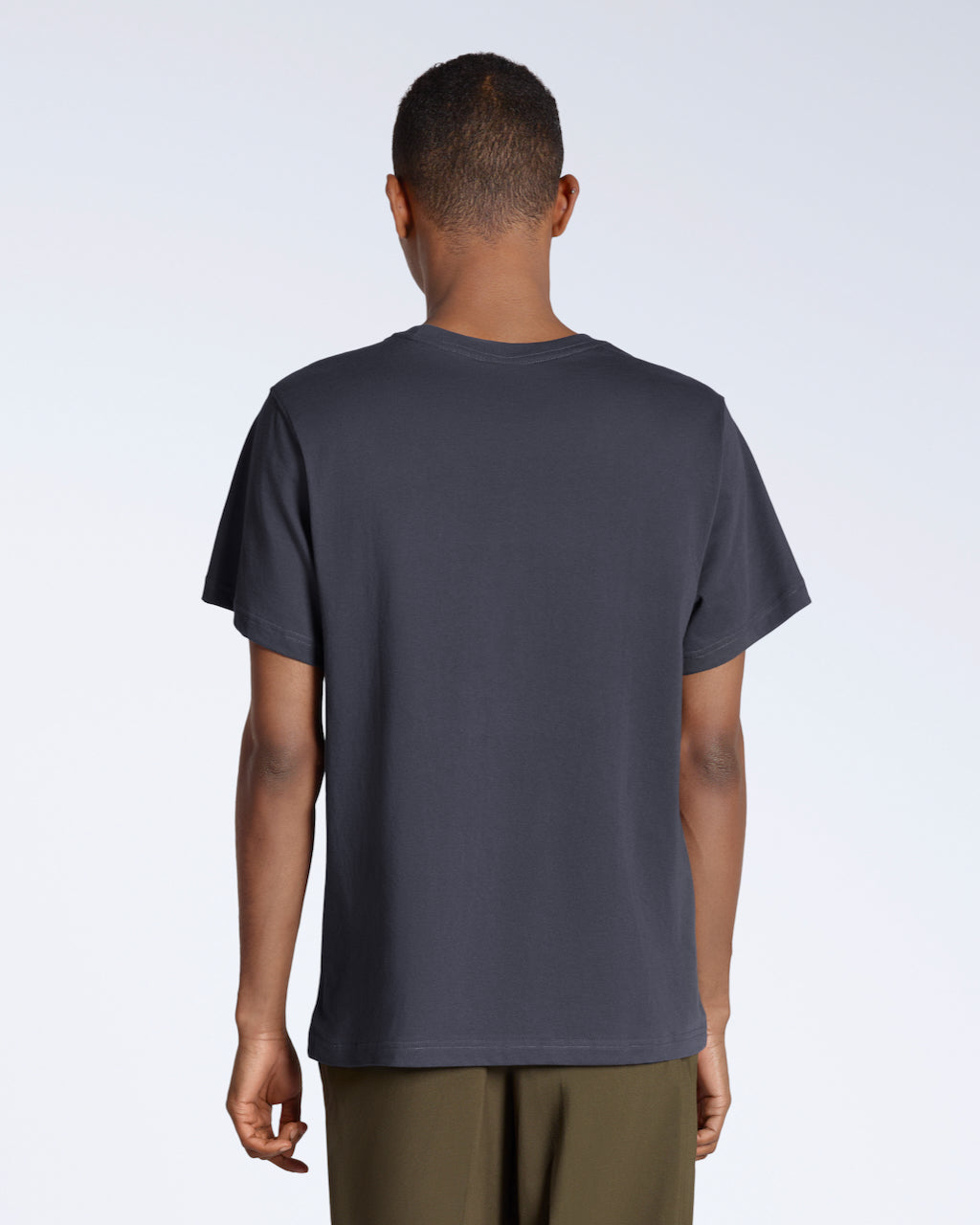 A man facing away from the camera, modelling a plain dark grey, short sleeve organic cotton t shirt.