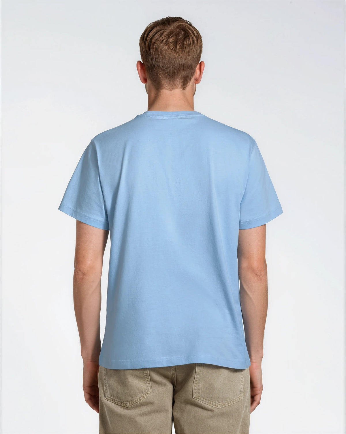 A man facing away from the camera, modelling a plain blue short sleeve organic cotton t shirt.
