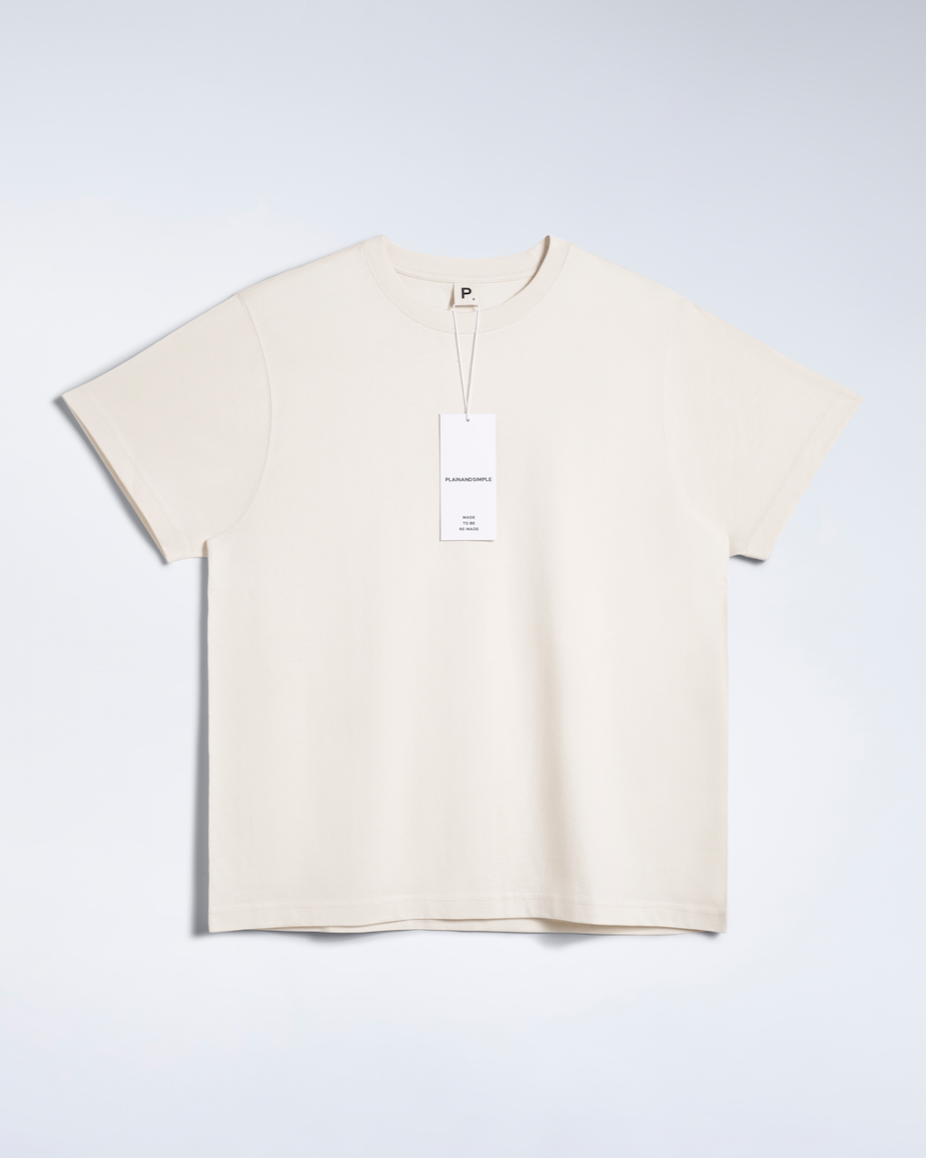 A flatlay of a natural coloured, oversized, premium weight, organic cotton t shirt.
