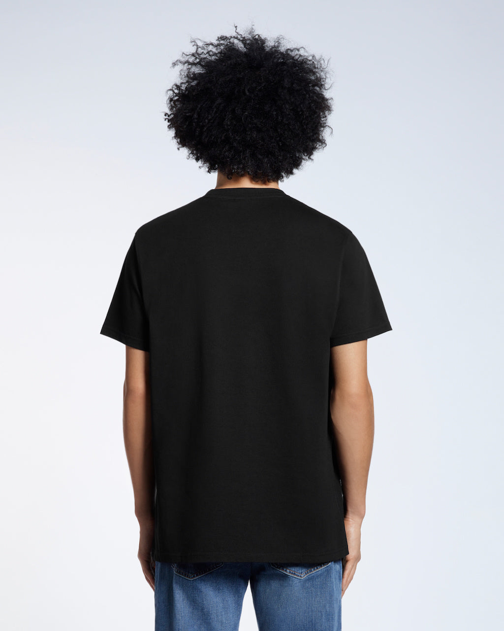 A man facing away from the camera, modelling a plain navy short sleeve organic cotton t shirt.