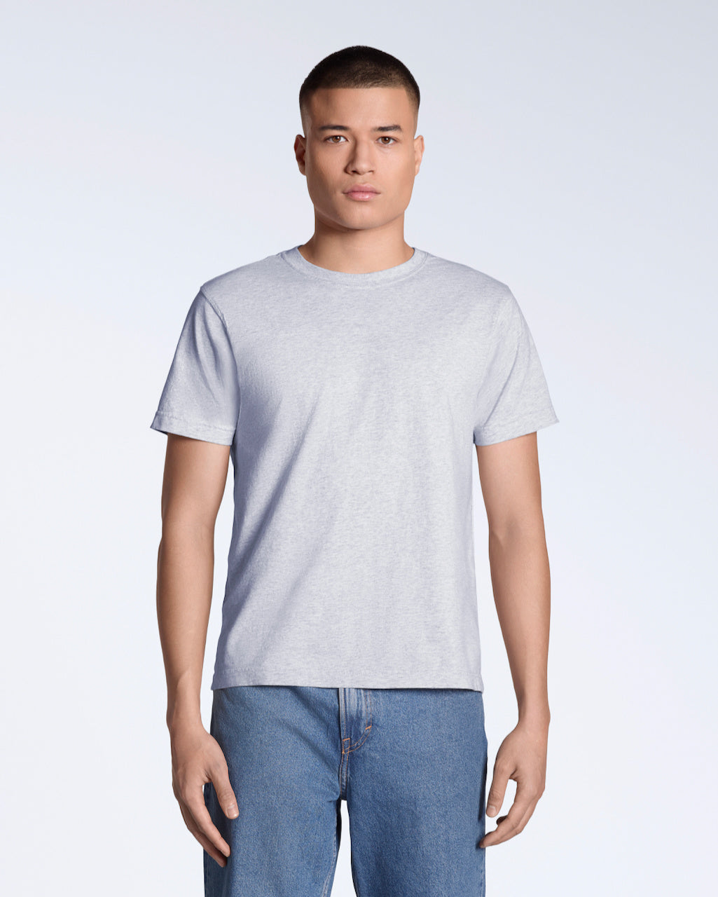 A man facing front on looking into the camera, modelling a plain grey short sleeve organic cotton t shirt.