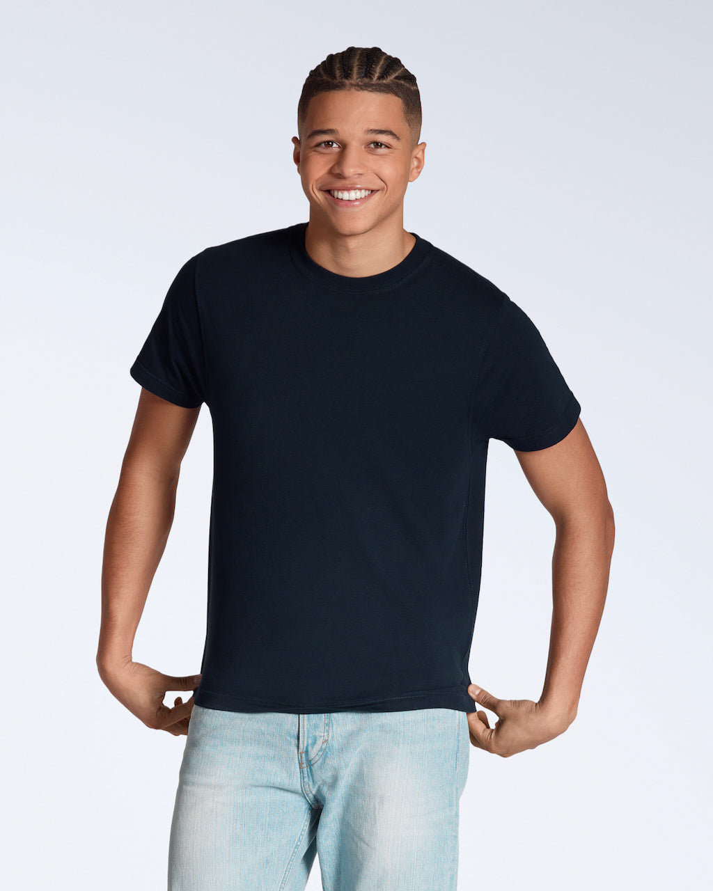 A man smiling into the camera, modelling a plain navy short sleeve organic cotton t shirt.