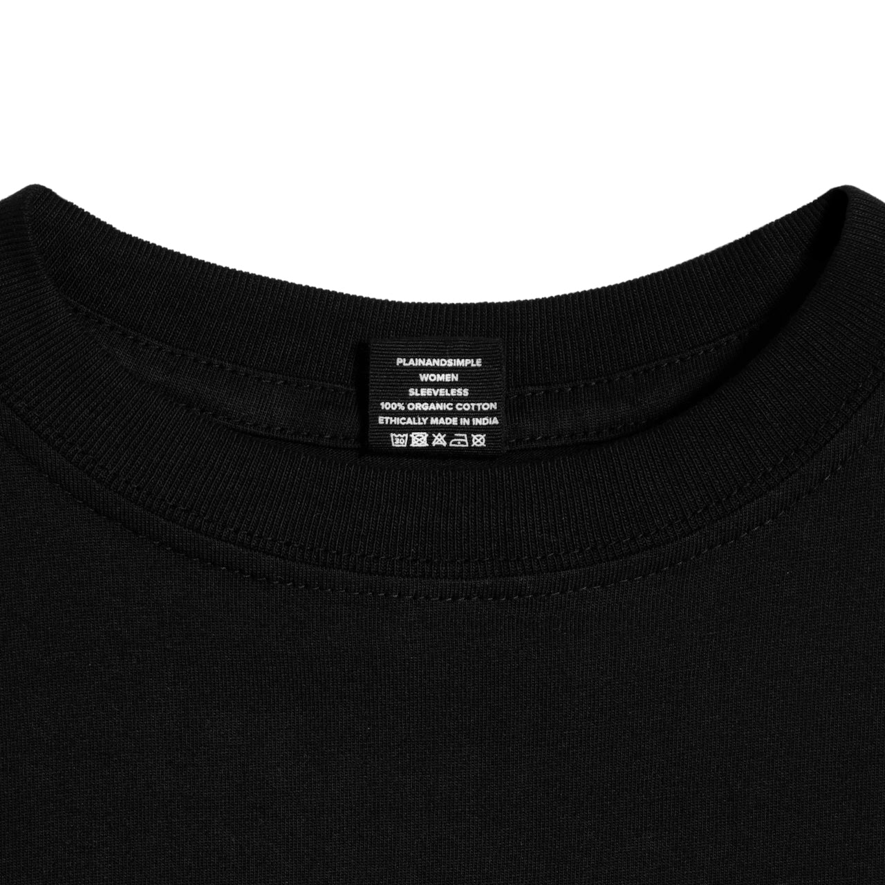 A close up of a neck label in a women's black sleeveless organic cotton crew neck tank top.