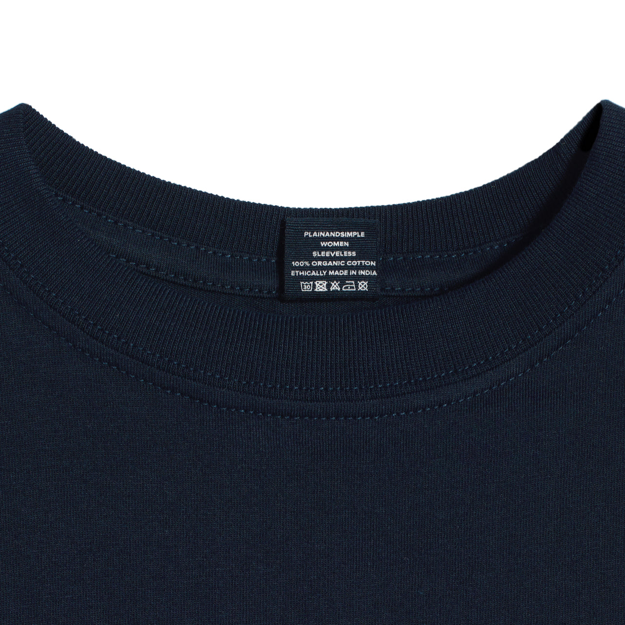 A close up of a neck label in a women's navy sleeveless organic cotton crew neck tank top.
