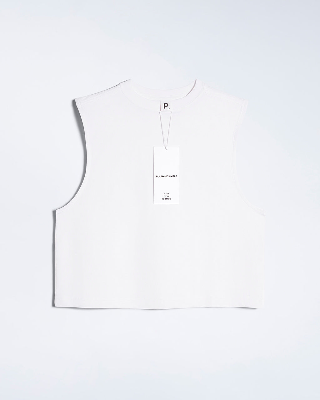 A flatlay of a women's plain white sleeveless organic cotton tank top.