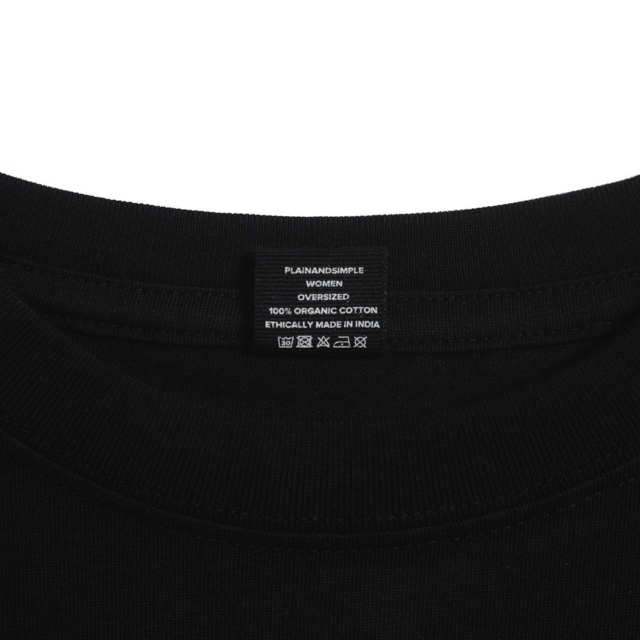 A close up of an neck label in a women's black boxy crew neck heavyweight organic cotton t shirt.