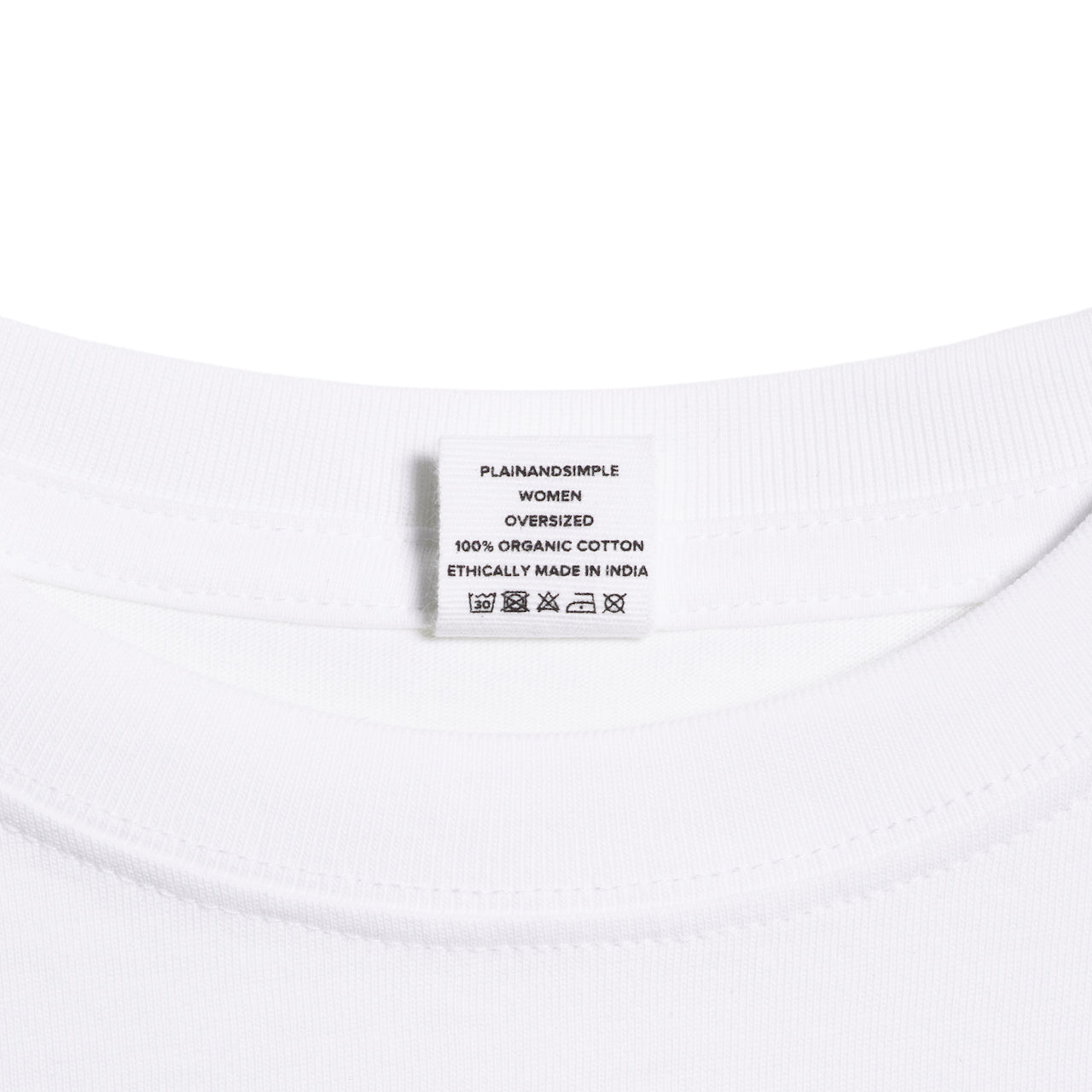 A close up of an neck label in a women's white boxy crew neck heavyweight organic cotton t shirt.