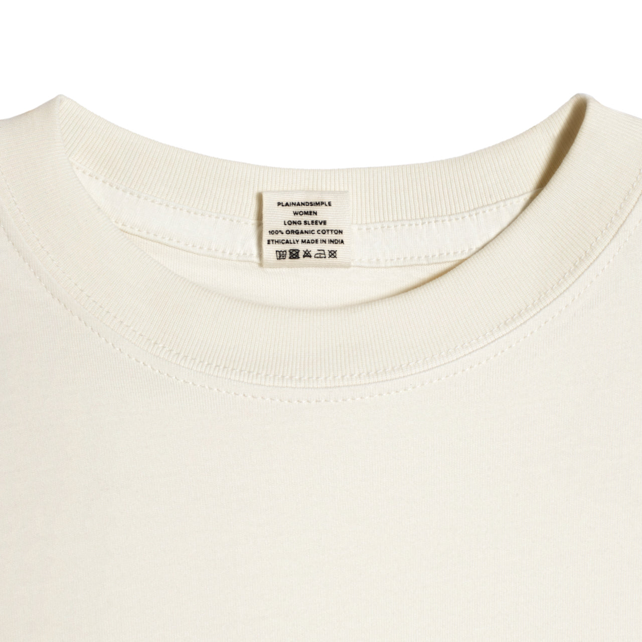 A close up of a neck label in a women's ecru long sleeve crew neck organic cotton t shirt.