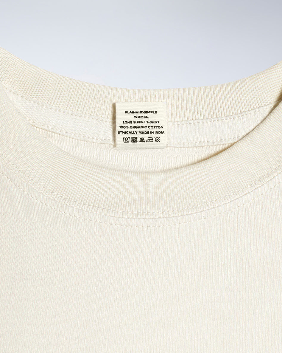 A close up of a neck label in a women's ecru long sleeve crew neck organic cotton t shirt.