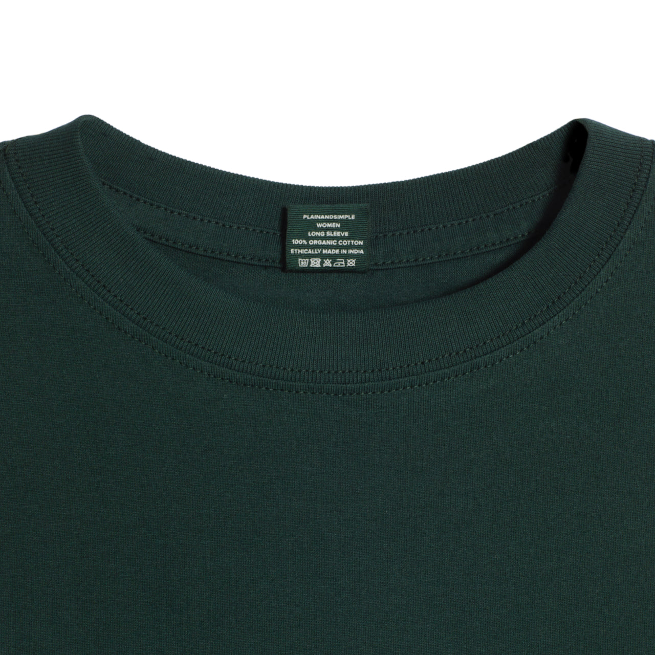 A close up of a neck label in a women's green long sleeve crew neck organic cotton t shirt.