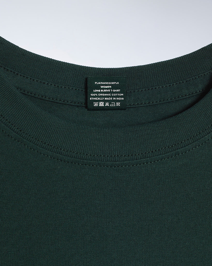 A close up of a neck label in a women's green long sleeve crew neck organic cotton t shirt.