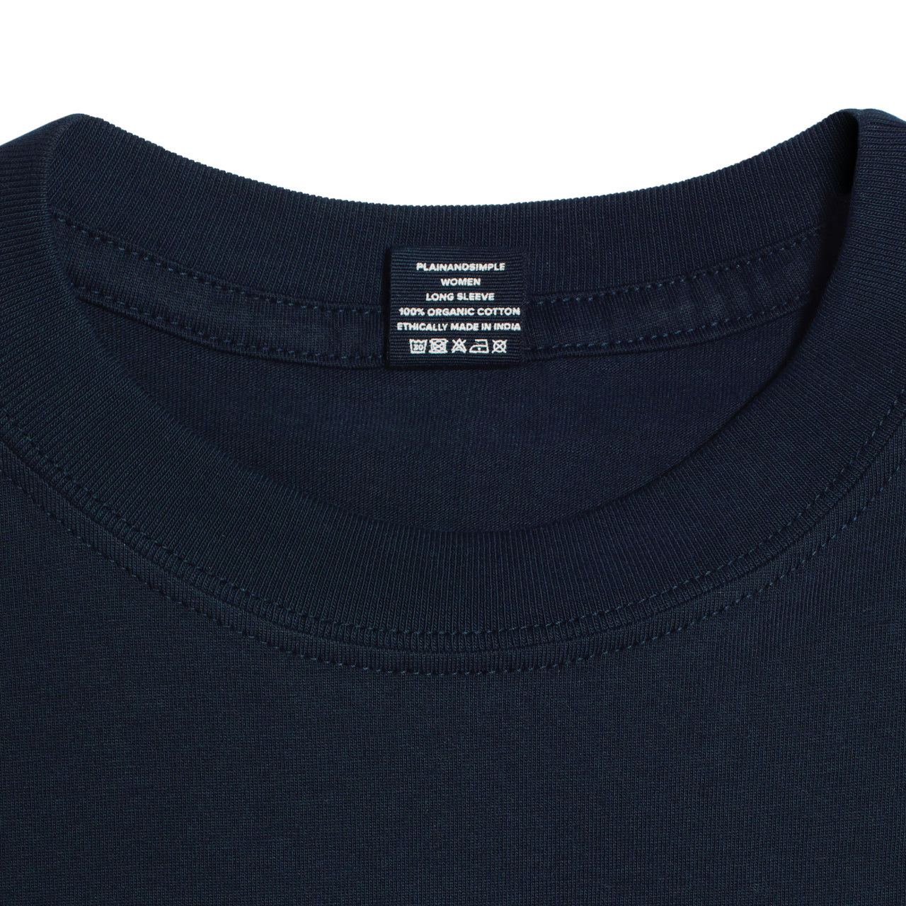 A close up of a neck label in a women's navy long sleeve crew neck organic cotton t shirt.