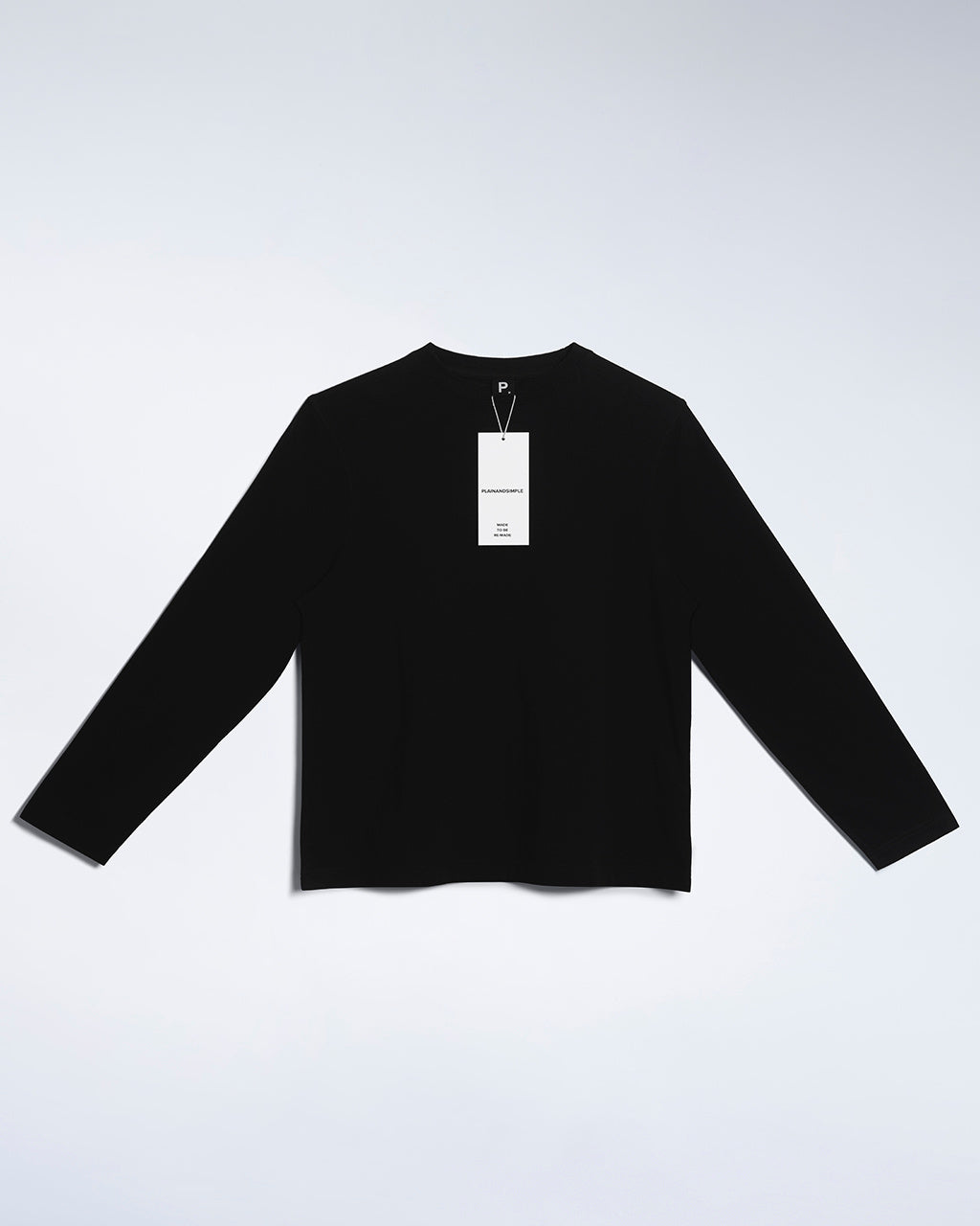 A flatlay of a women's plain black long sleeve crew neck organic cotton t shirt.