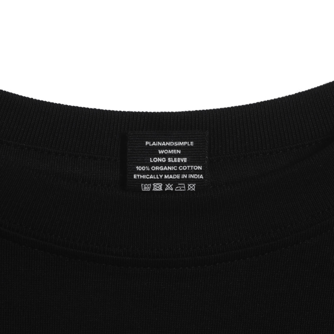 A close up of an neck label in a women's black long sleeve crew neck organic cotton t shirt.
