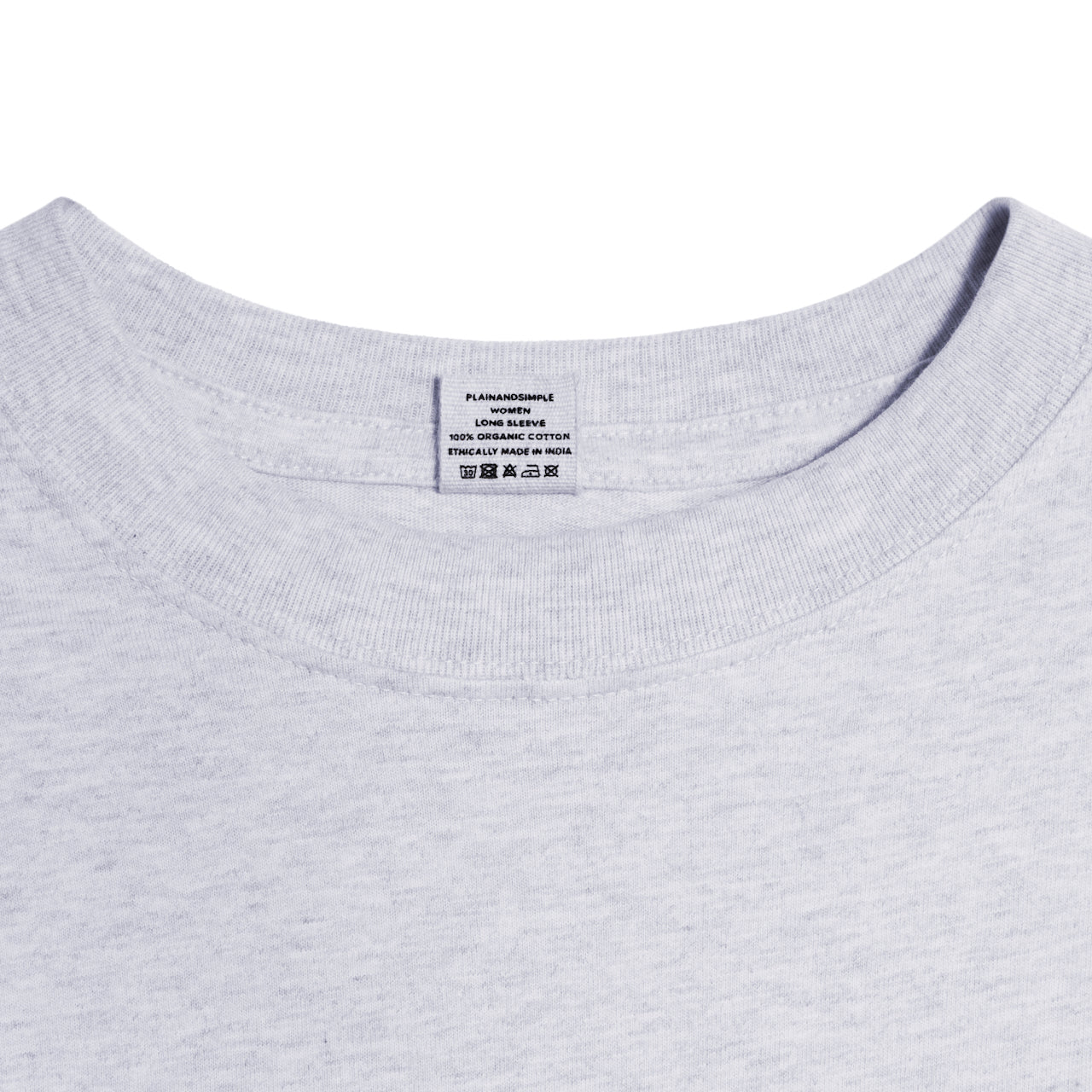 A close up of a neck label in a women's grey long sleeve crew neck organic cotton t shirt.