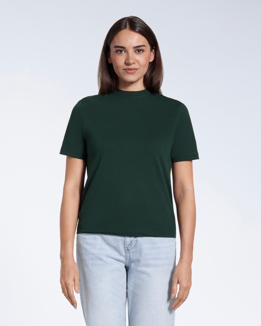 A woman facing front on looking at the camera, modelling a green short sleeve organic cotton t shirt.