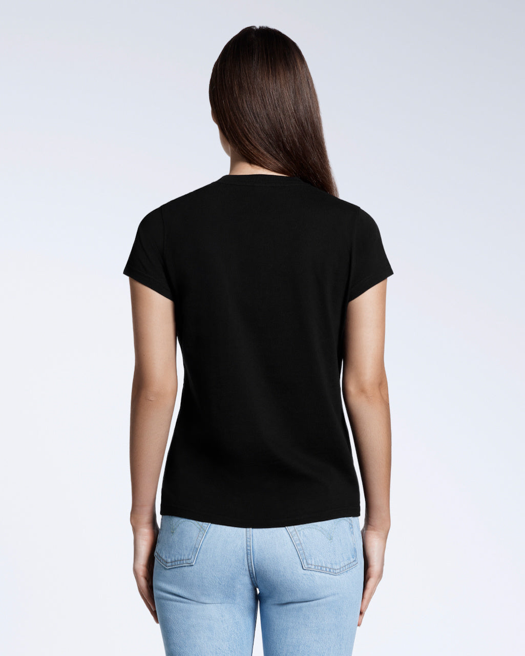A woman with her back to the camera, modelling a plain black short sleeve organic cotton t shirt.