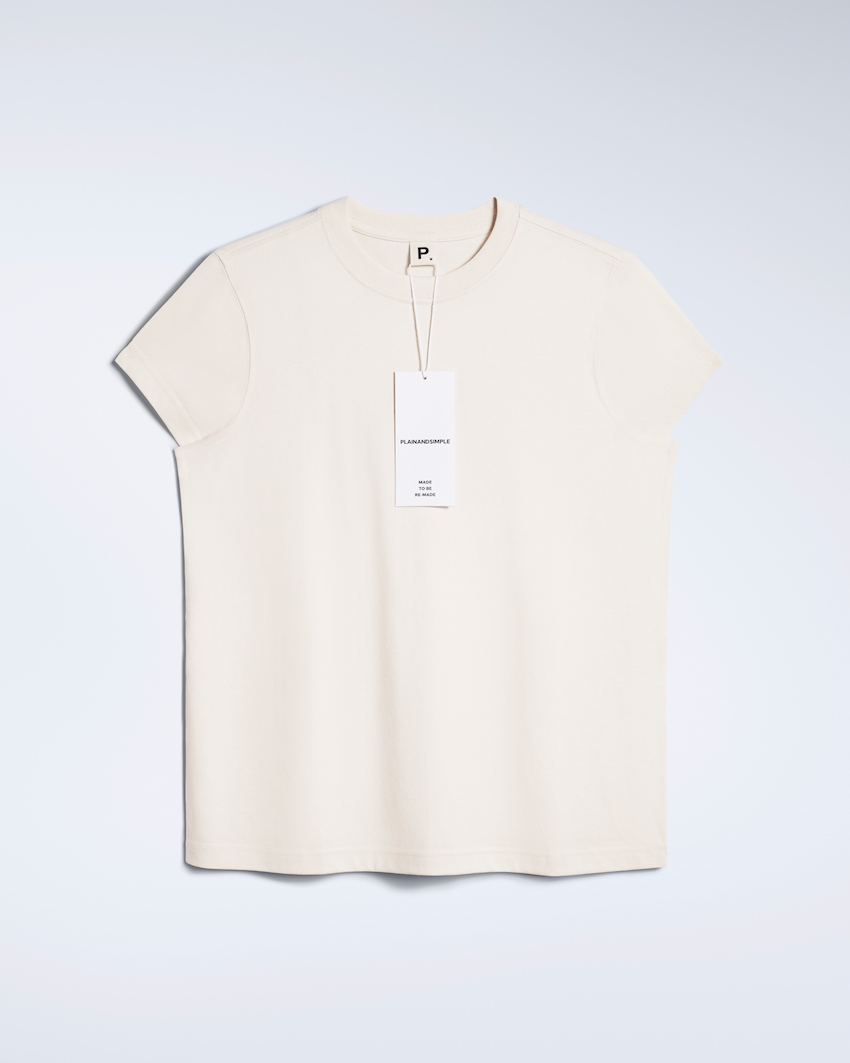 A flatlay of a natural coloured, crew neck, organic cotton t shirt.