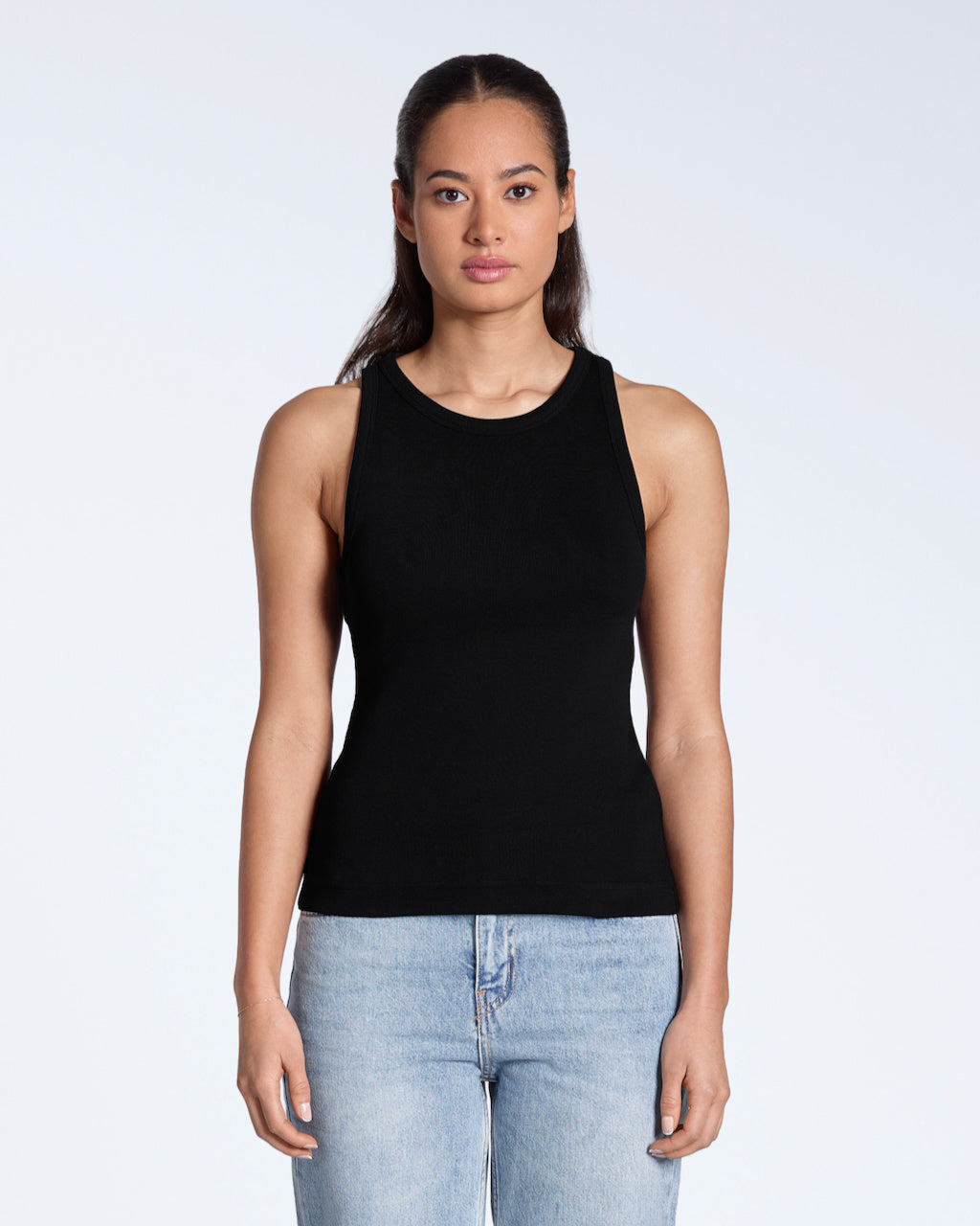 A woman facing front on, modelling a plain black, organic cotton tank top.