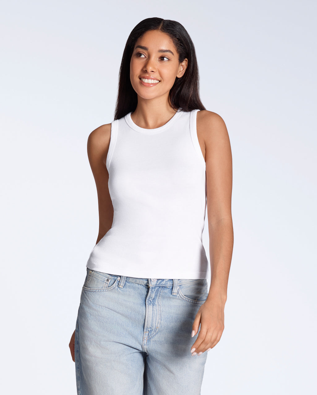 A woman smiling, modelling a plain white, organic cotton tank top.