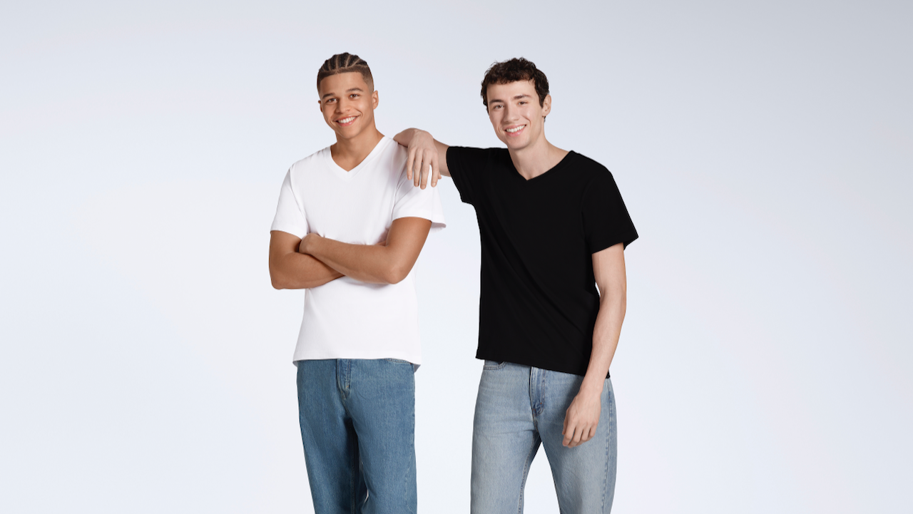 Two men smiling into the camera, modelling plain white and black, organic cotton, v neck t shirts.