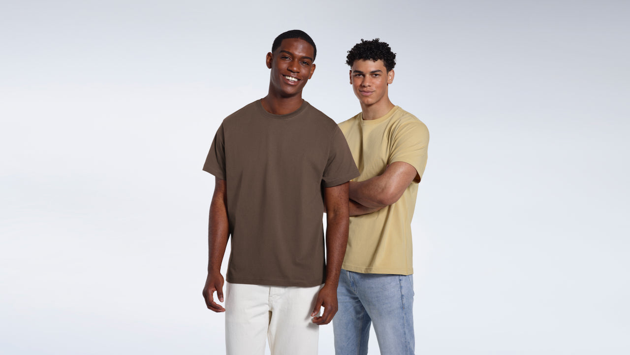 Two men smiling, modelling plain dark and light khaki organic cotton t shirts.