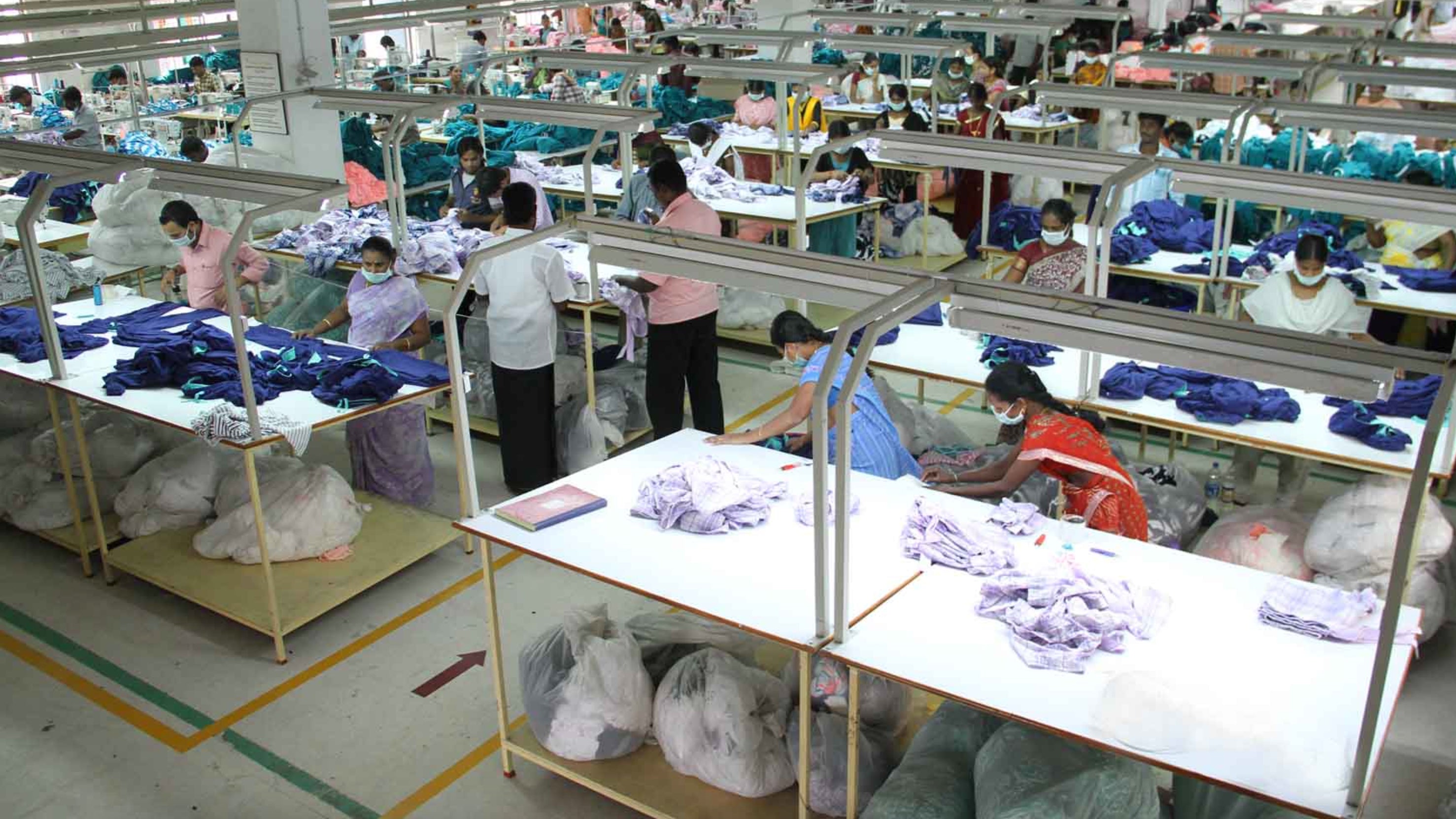A photo of factory workers processing garments at an ethical garment supplier in India.