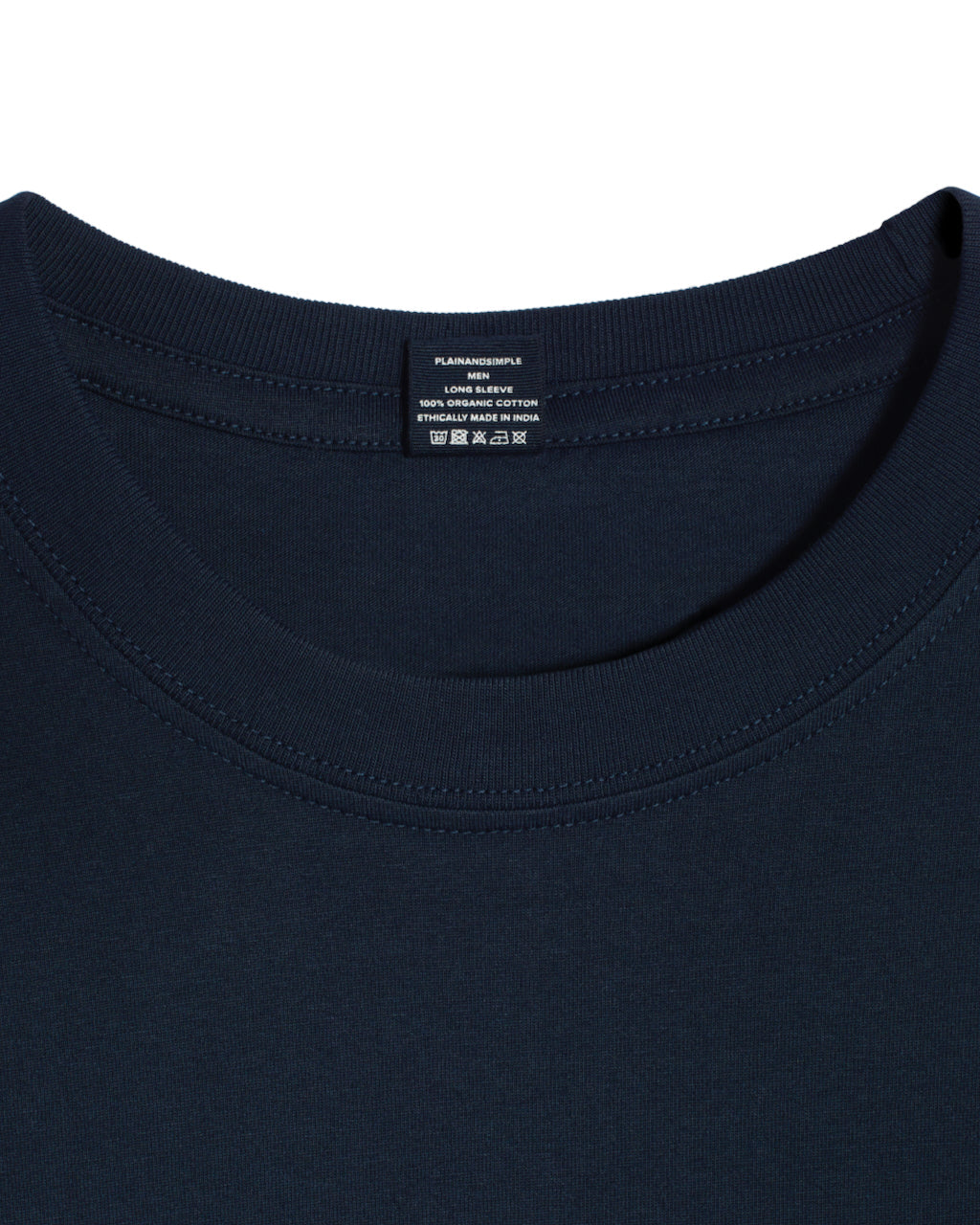 A close up of a neck label in a men's dark navy sleeve crew neck organic cotton t shirt.