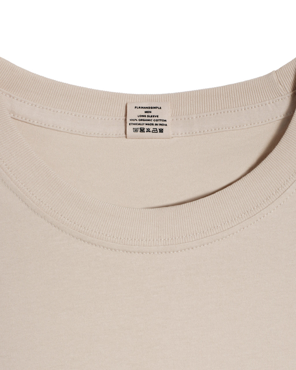 A close up of a neck label in a men's stone long sleeve crew neck organic cotton t shirt.