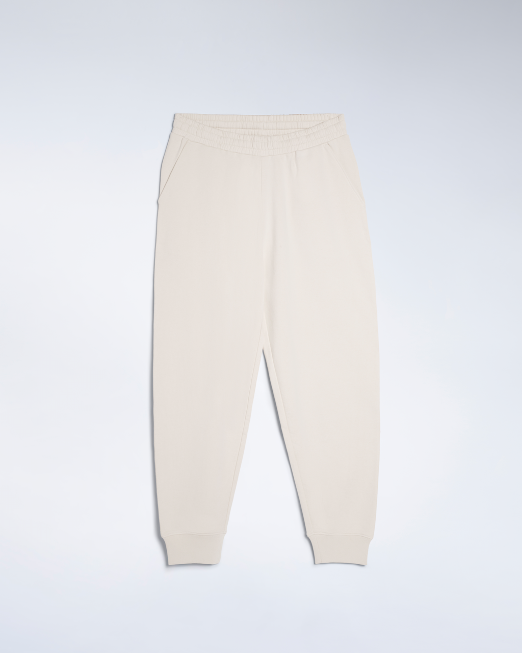 A flatlay of a pair of natural coloured, organic cotton joggers.