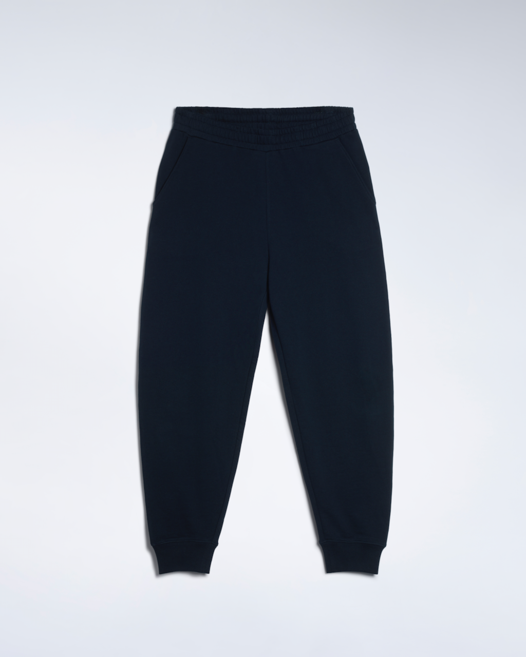 A flatlay of a pair of navy, organic cotton joggers.