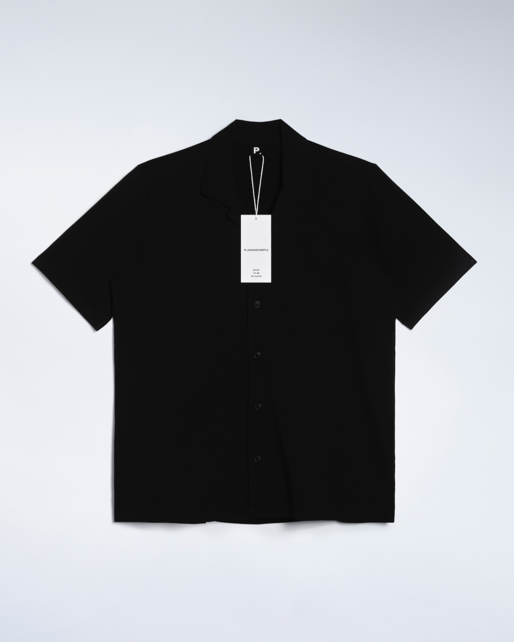A flatlay of a black, organic cotton resort shirt.