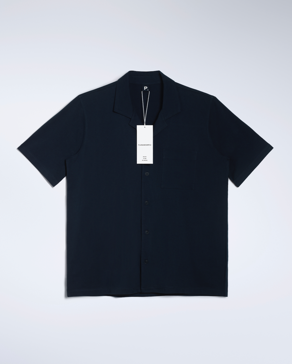 A flatlay of a navy, organic cotton resort shirt.