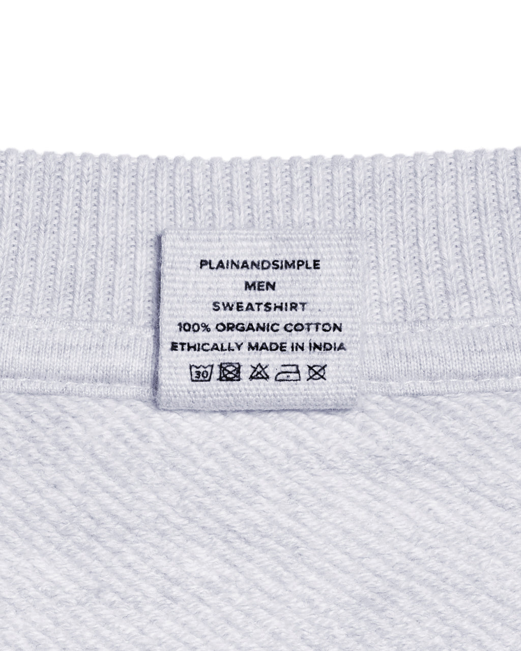 A close up of a neck label in a men's grey oversized heavyweight organic cotton sweatshirt.