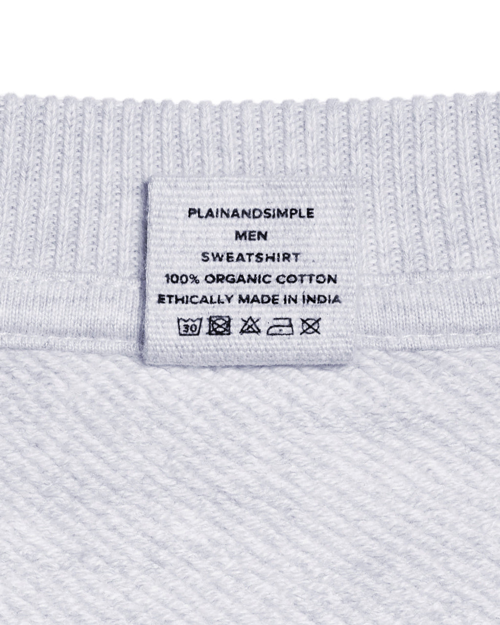 A close up of a neck label in a men's grey oversized heavyweight organic cotton sweatshirt.