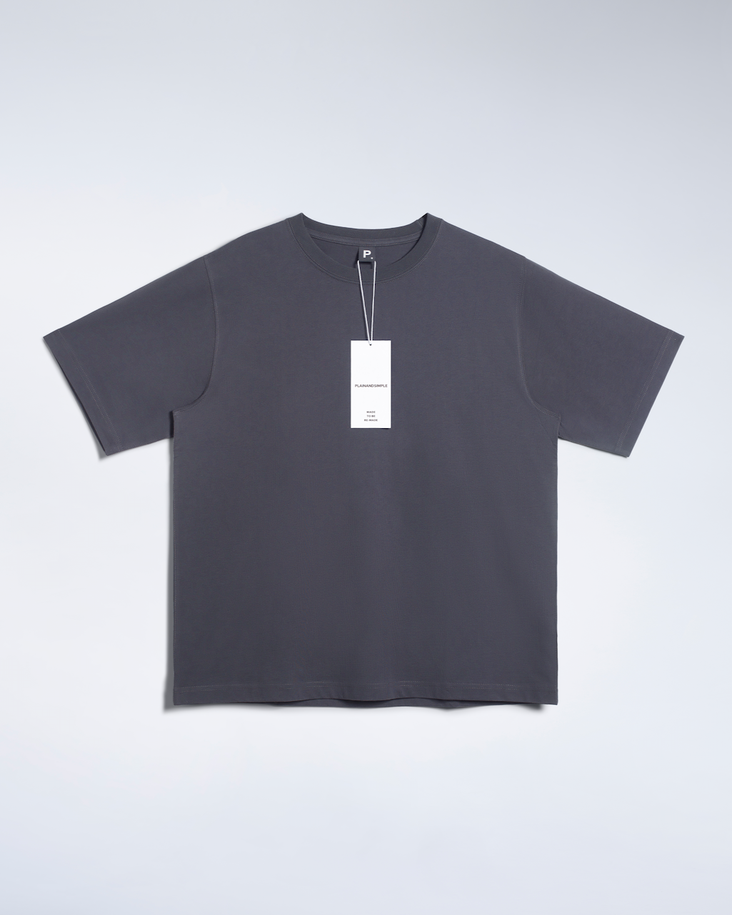 A flatlay of a dark grey, oversized, heavyweight, organic cotton t shirt.