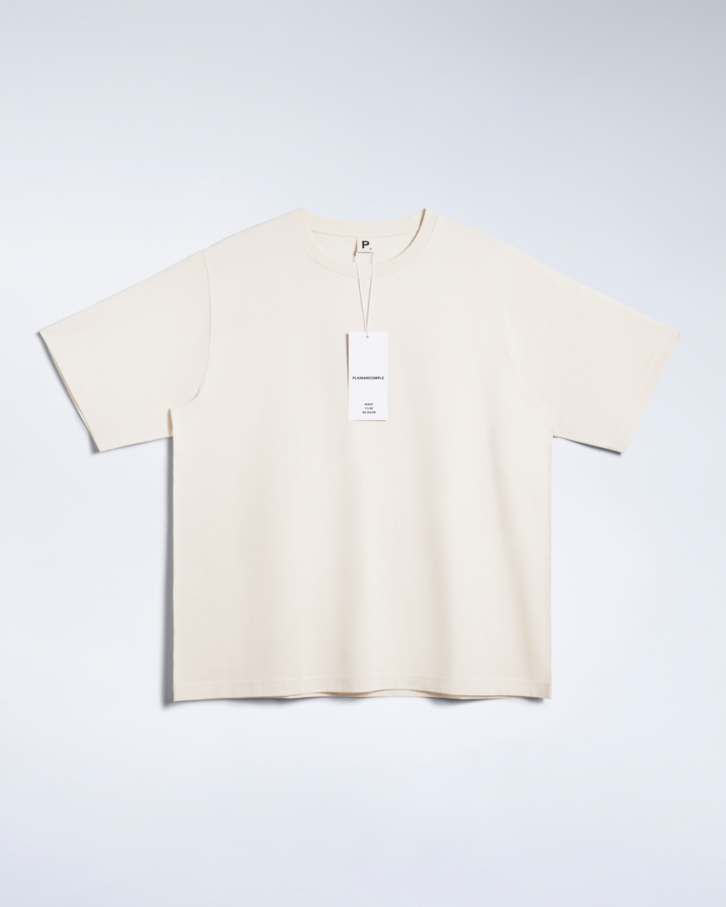 A flatlay of a natural coloured, oversized, heavyweight, organic cotton t shirt.