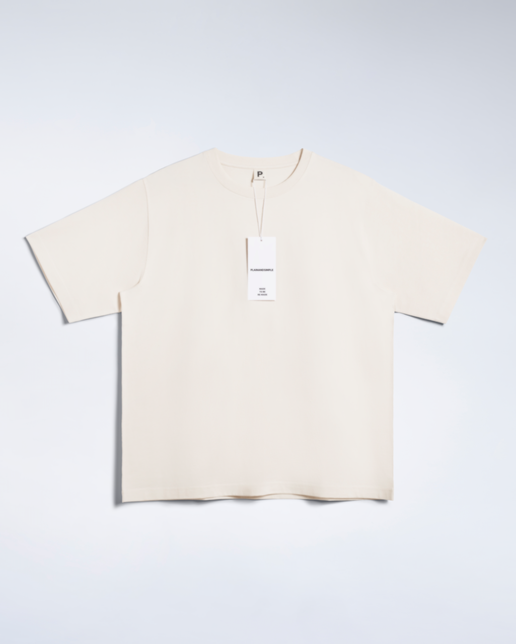 A flatlay of a natural coloured, oversized, heavyweight, organic cotton t shirt.