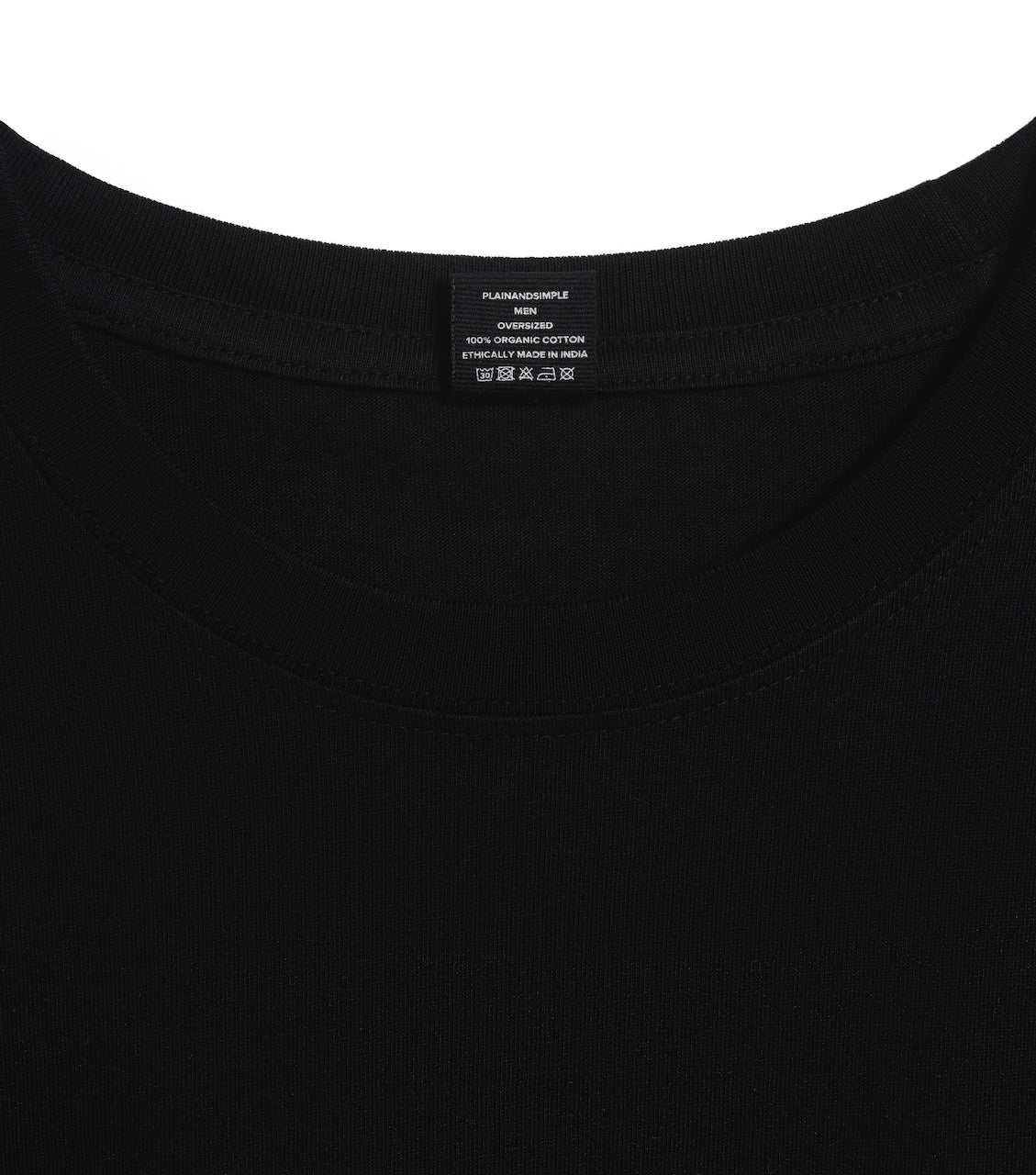 A close up of an neck label in a men's black oversized heavyweight organic cotton t shirt.