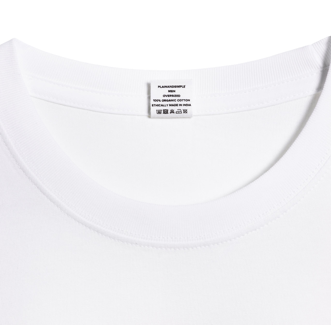 A close up of an neck label in a men's white oversized heavyweight organic cotton t shirt.