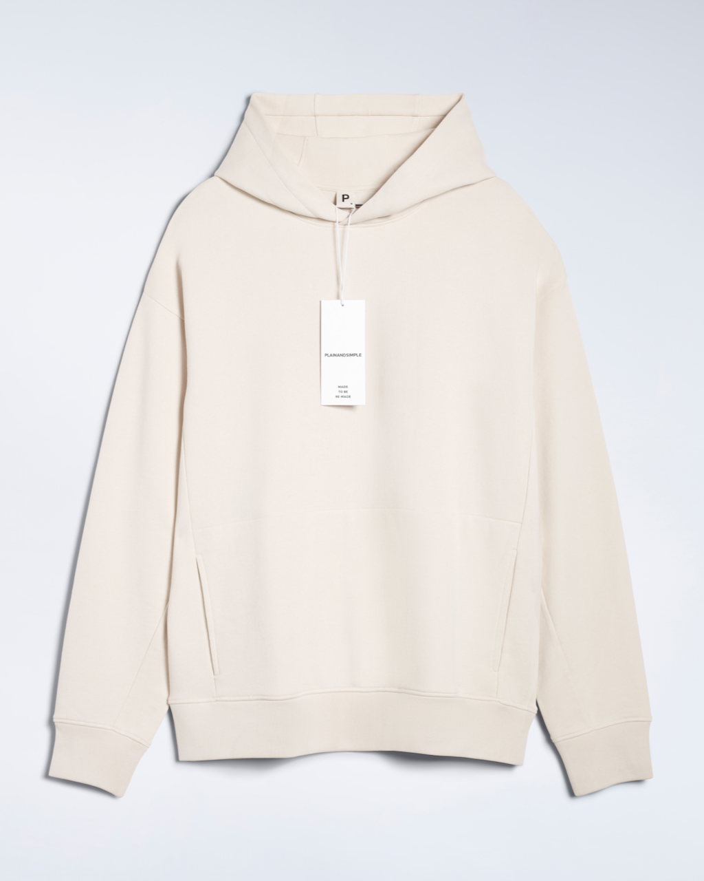 A flatlay of a natural coloured, oversized, organic cotton hoodie.