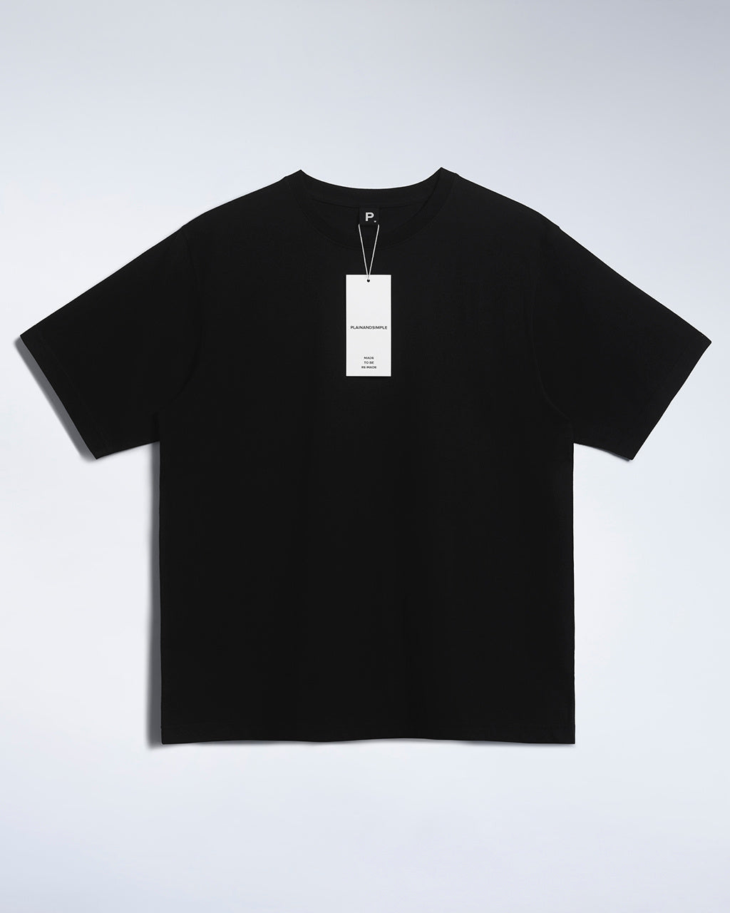 A flatlay of a men's black, oversized, organic cotton t shirt.