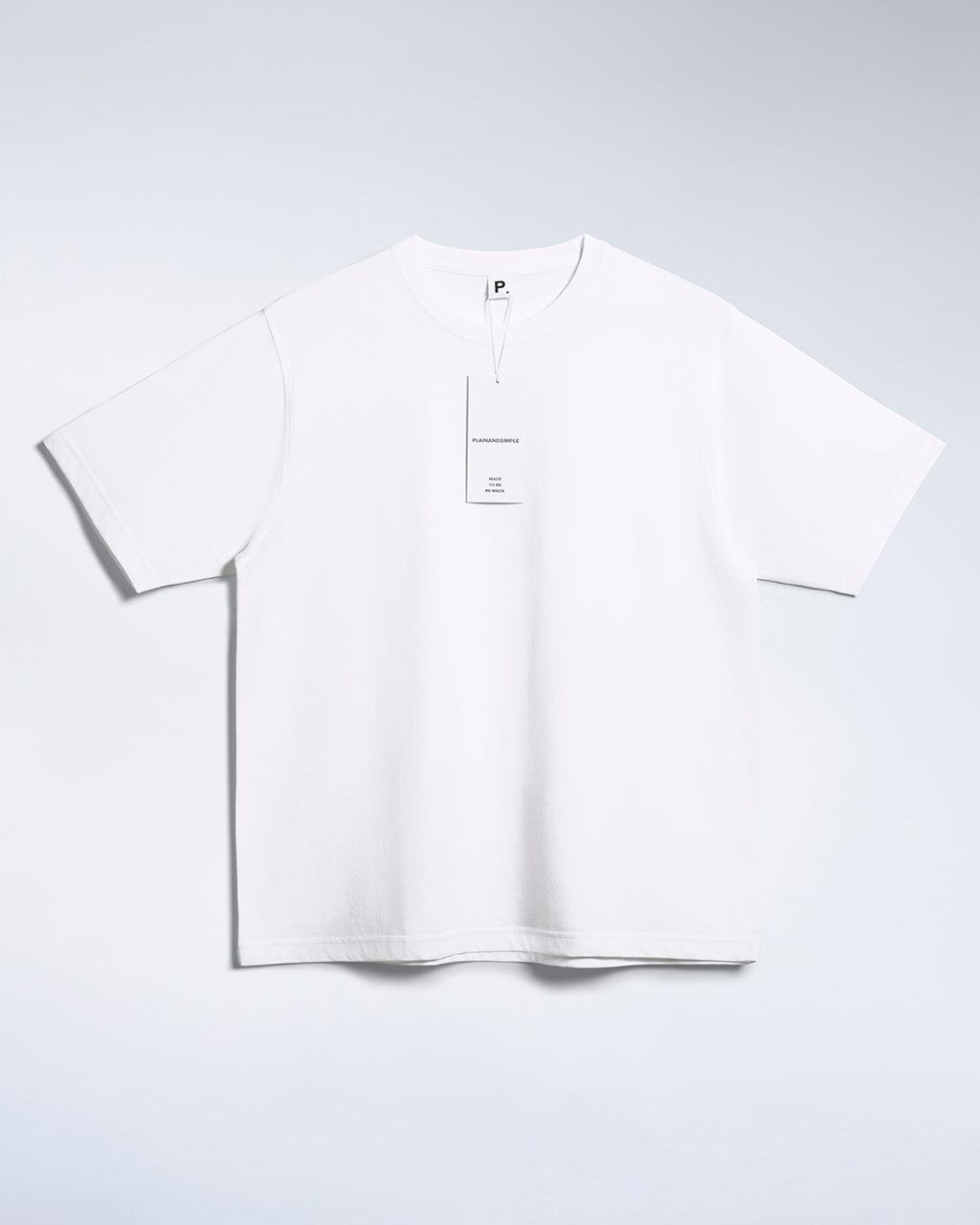 A flatlay of a men's white, oversized, organic cotton t shirt.