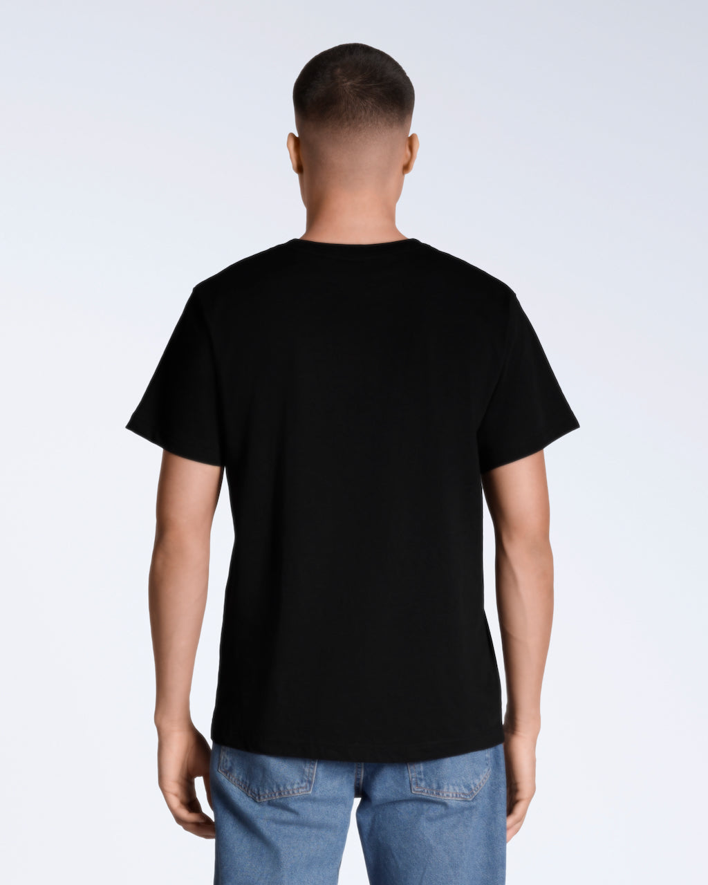A man facing away from the camera, modelling a plain black short sleeve organic cotton t shirt.