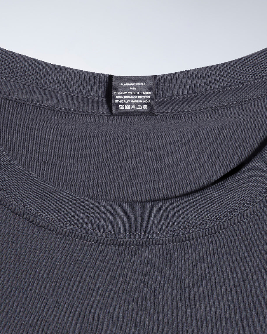 A close up of a neck label in a men's dark grey short sleeve crew neck organic cotton t shirt.
