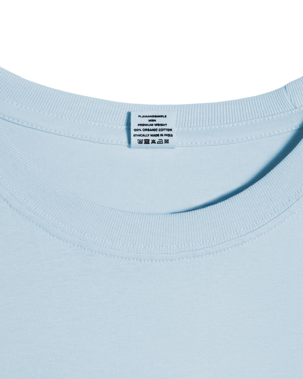 A close up of a neck label in a men's light blue short sleeve crew neck organic cotton t shirt.