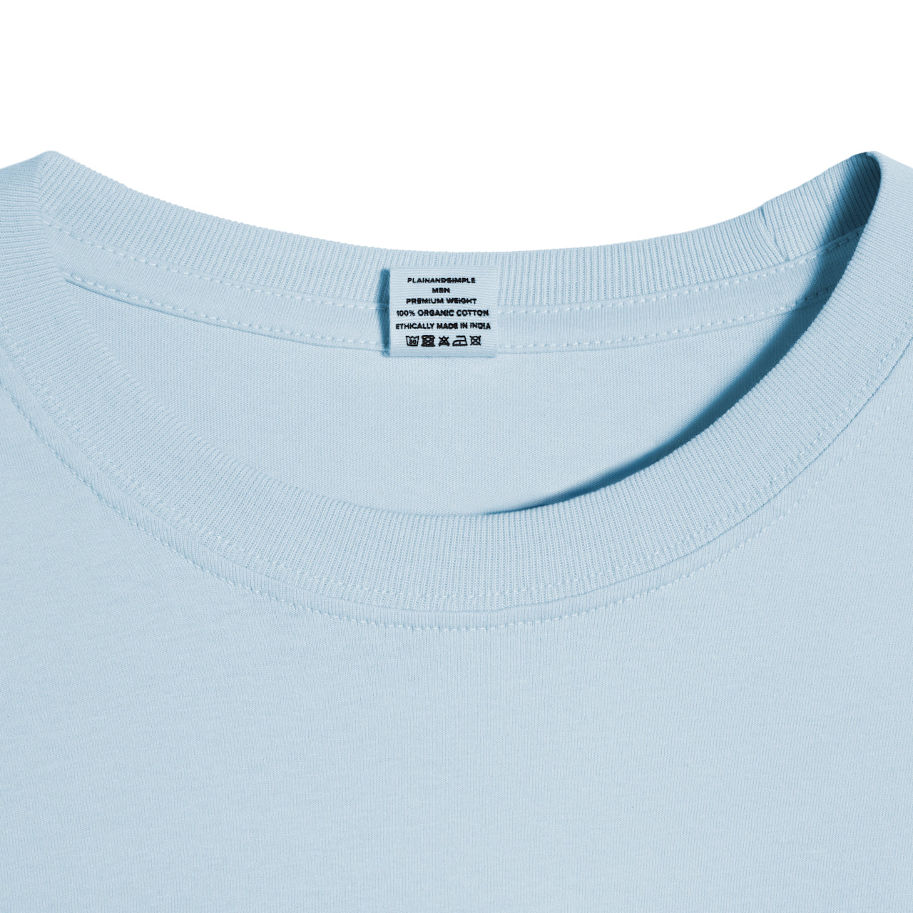 A close up of a neck label in a men's light blue short sleeve crew neck organic cotton t shirt.